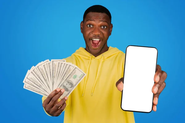 Excited Young African American Man Yellow Hoodie Shows Stack Money — 스톡 사진