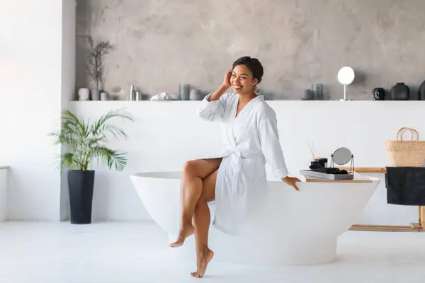 Wellness Concept Beautiful Black Woman Wearing Bathrobe Sitting Bathtub Home — Foto de Stock