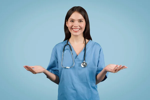 Young Woman Nurse Blue Coat Gesturing Camera Engaging Online Consultation — стокове фото