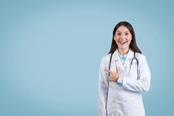Excited Female Doctor Pointing Side Copy Space Showing Something Exciting — стокове фото