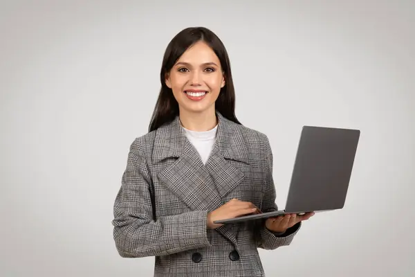 Confident Young Businesswoman Checkered Suit Holding Open Laptop Friendly Smile — 图库照片