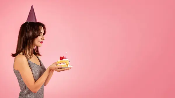 Smiling Woman Sparkly Dress Party Hat Admiring Lit Birthday Cake — Fotografia de Stock