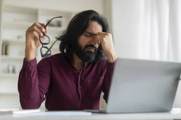 Stressed Indian Freelancer Guy Feeling Unwell While Working Laptop Home — Stock Photo, Image