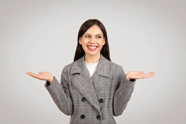 Cheerful Young Businesswoman Plaid Coat Her Hands Raised Weighing Options — Stock Photo, Image