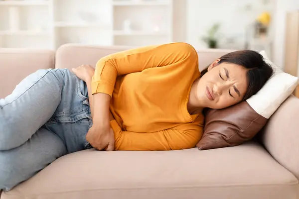 Sick Young Asian Woman Laying Couch Closed Eyes Home Touching — Stock Photo, Image