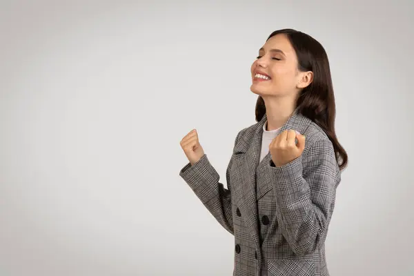 Exuberant Young Woman Jacket Eyes Closed Raising Clenched Fists Gesture — Stock Photo, Image