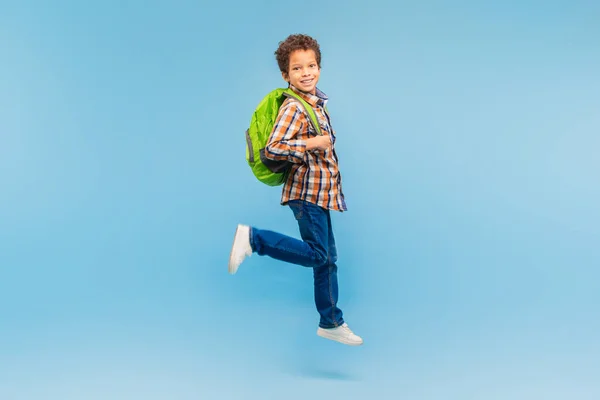 Lively Boy Caught Mid Stride Wearing Plaid Shirt Green Backpack — Stock Photo, Image