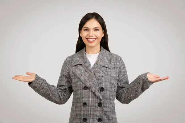 Joyful Young Woman Plaid Blazer Hands Outstretched Palms Happily Balancing — Stock Photo, Image