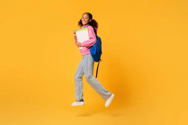 Happy Black Teen Student Girl Jumping Blue Backpack College Workbooks — Stock Photo, Image