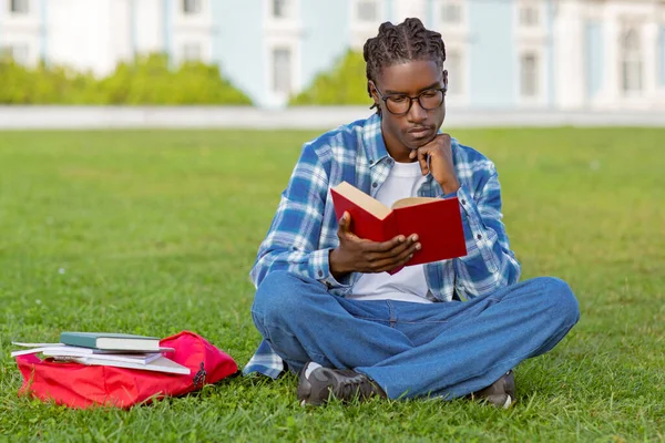 Thoughtful Black Student Guy Reading Book Doing His Homework Sitting — Stock Photo, Image