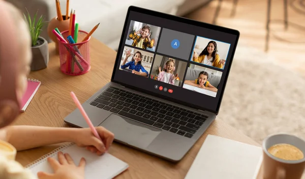 Home schooling concept. Little girl wearing wireless headphones sitting at desk, have online lesson with teacher and classmates, looking at laptop with video chat screen, collage