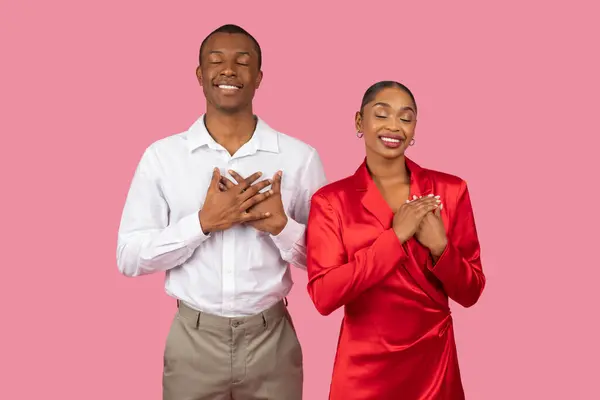 Black Couple Elegant Attire Hands Hearts Eyes Closed Expressing Gratitude — Stock Photo, Image