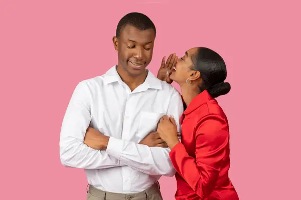 Black Woman Red Dress Whispers Ear Smiling Man White Shirt — Stock Photo, Image