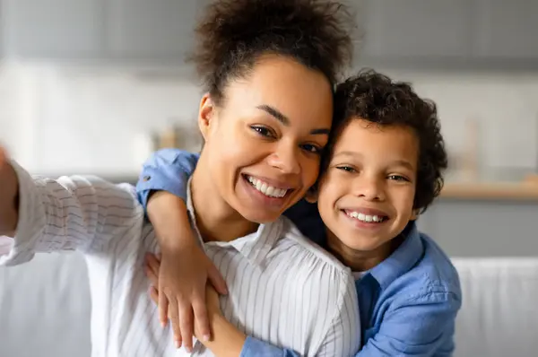 带着快乐的笑容 黑人母亲和她十几岁的儿子开始自私自利 在家里客厅里捕捉着幸福和亲密的瞬间 — 图库照片