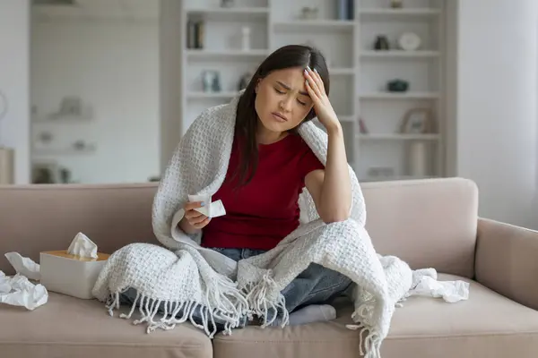 Ill Asian Woman Headache Sitting Couch Home Surrounded Tissues Sick — Stock Photo, Image