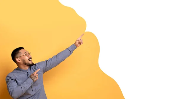 伟大的报价 快乐的亚洲男人用双手指示复制空间指向手指 演示黄色工作室背景上的空白文字泡泡 看那里的概念 — 图库照片