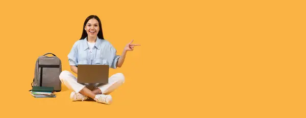 Enthusiastic European Female Student Sitting Cross Legged Laptop Lap Pointing — Stock Photo, Image
