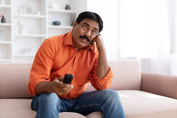 Unhappy Mature Eastern Man Moustache Sitting Couch Alone Home Holding — Stock Photo, Image