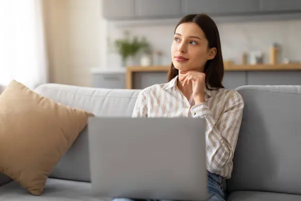 Pensive Young Woman Striped Shirt Using Laptop Computer While Sitting — Stock Photo, Image