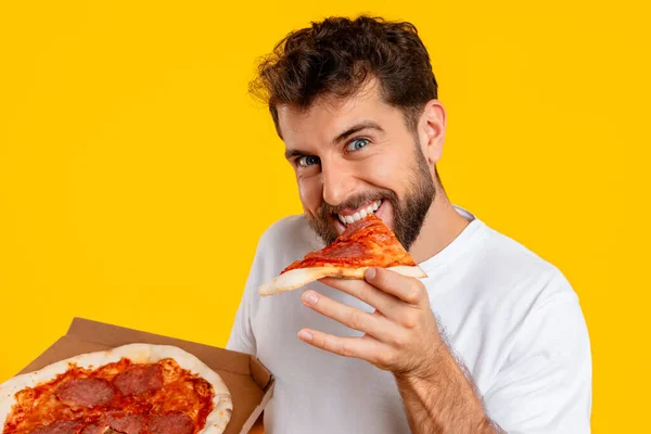 Junk Food Eater Cheerful Young European Guy Bites Slice Pizza — Stock Photo, Image