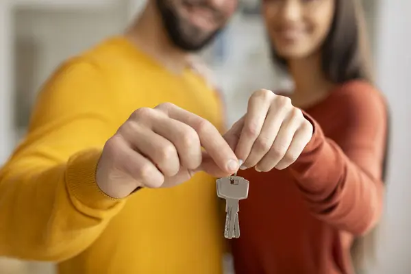 Real Estate Concept. Closeup Shot Of Young Couple Holding Home Keys, Smiling Millennial Spouses Celebrating Buying Property, Man And Woman Moving To Their Own House, Selective Focus, Cropped
