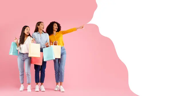 Three Excited Diverse Ladies Colorful Shopping Bags Pointing Empty Text — Stock Photo, Image