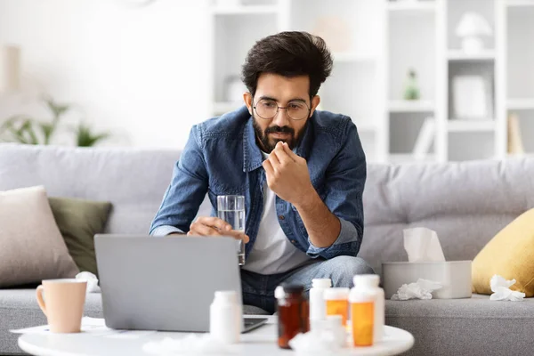 Telemedicine Concept Sick Indian Man Looking Laptop Taking Medication Glass — Stock Photo, Image