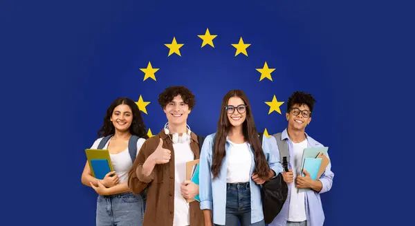 Four diverse young students smiling with books and backpacks, giving a thumbs up in front of a European Union flag background, symbolizing educational exchange programs, panorama