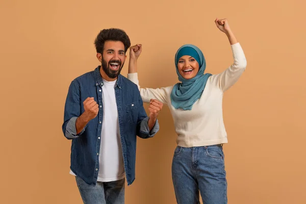Emotional Young Muslim Couple Celebrating Success Clenching Fists Screaming Happy — Stock Photo, Image