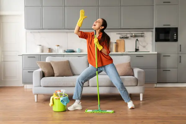 Delighted Woman Casual Attire Enjoys Dancing While Cleaning House Holding — Stock Photo, Image
