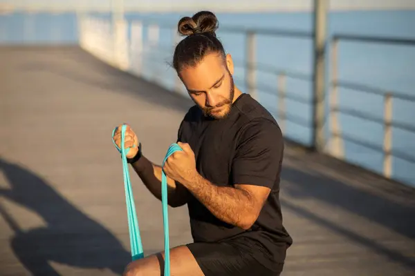 Athletic Guy Black Fitness Attire Exercising Resistance Rubber Band Doing — Stock Photo, Image