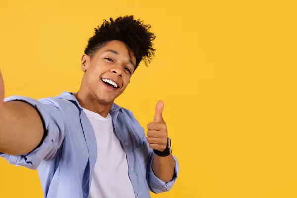 Exuberant Young Man Curly Hair Takes Selfie Shows Thumbs Gesture — Stock Photo, Image