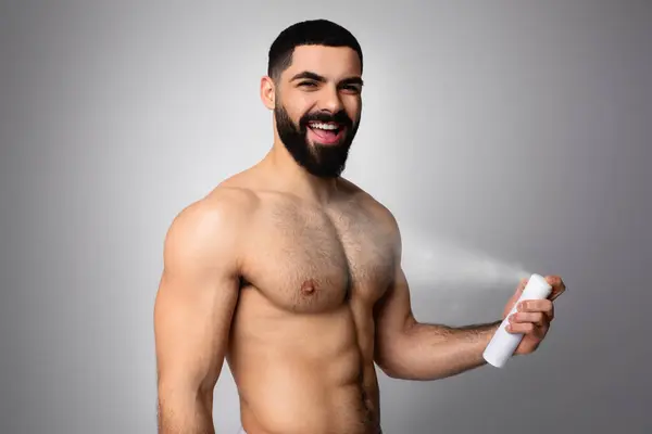 Shirtless Young Bearded Middle Eastern Man Using Deodorant Spray Underarm — Stock Photo, Image