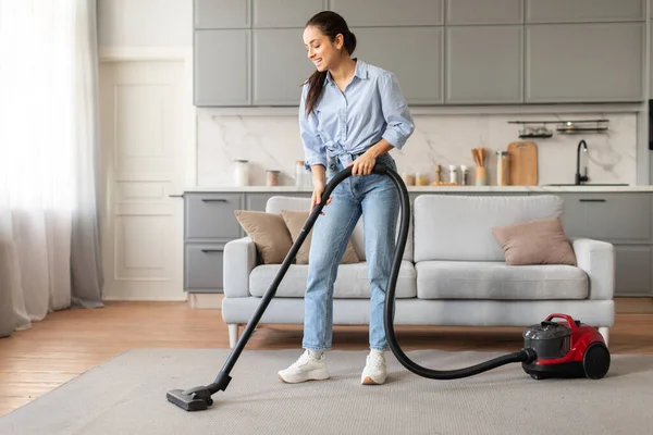 Cheerful Woman Blue Shirt Jeans Using Vacuum Cleaner Carpet Living — Stock Photo, Image