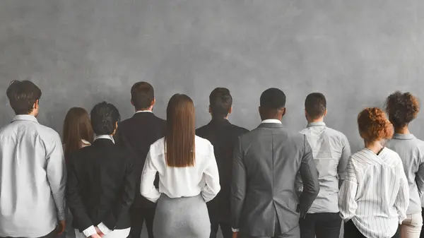 Business Team Standing Row Looking Grey Wall Empty Space Back — Stock Photo, Image