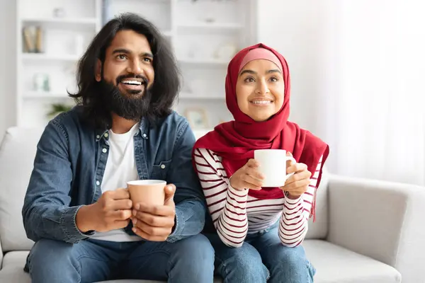 Happy Muslim Couple Drinking Coffee Relaxing Couch Living Room Cheerful — Stock Photo, Image