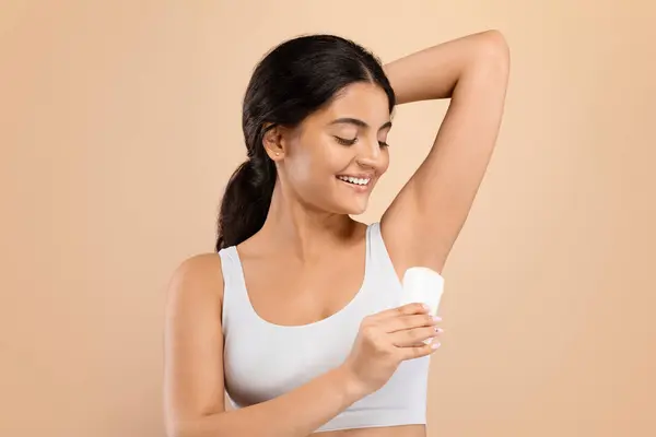 Henkilökohtainen Hygienia Hymyilevä Nuori Intialainen Nainen Soveltamalla Deodorantti Kiinni Underarm — kuvapankkivalokuva