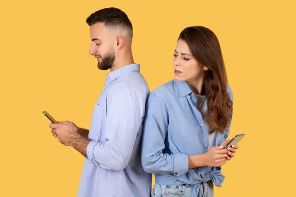 Kadın Erkek Akıllı Telefonuna Merakla Bakarken Ikisi Cihazlarına Dalmış Sarı — Stok fotoğraf