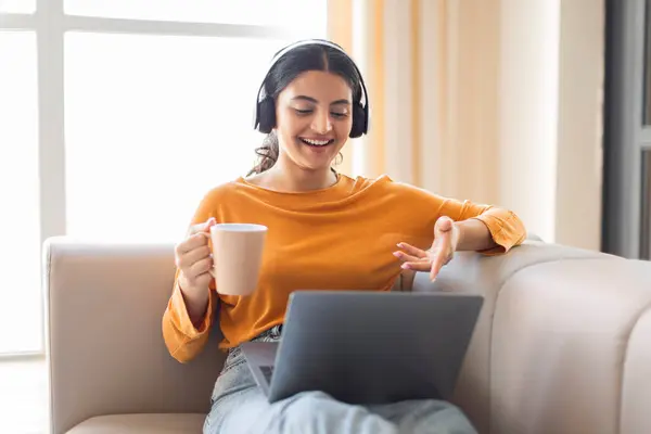 Relaxed Young Indian Woman Wearing Headphones Enjoying Cup Coffee Making — Stock Photo, Image