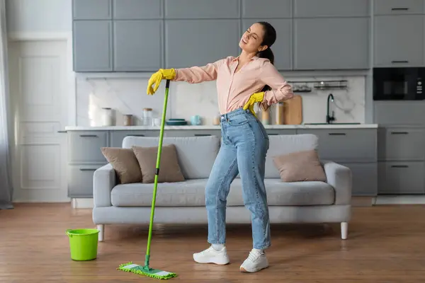 Exhausted Young Woman Casual Wear Pauses Leaning Green Mop Feeling — Stock Photo, Image