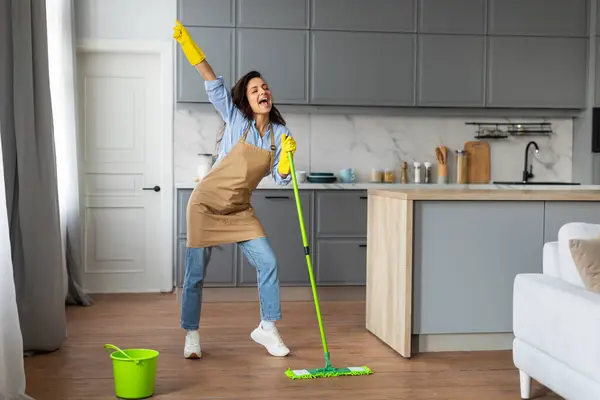 Vivacious Young Woman Yellow Gloves Using Green Mop Makeshift Microphone — Stock Photo, Image
