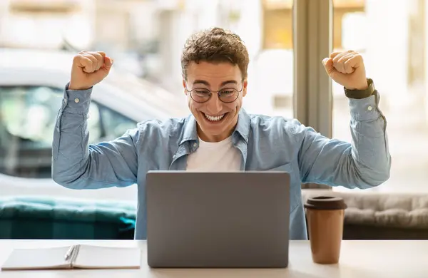 Joyful Young European Man Glasses Using Laptop Rises Fists Celebrate — Stock Photo, Image