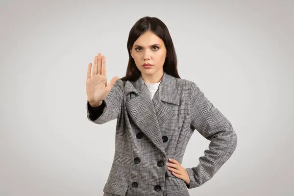 Serious Young Woman Checkered Blazer Extends Her Hand Forward Stop — Stock Photo, Image