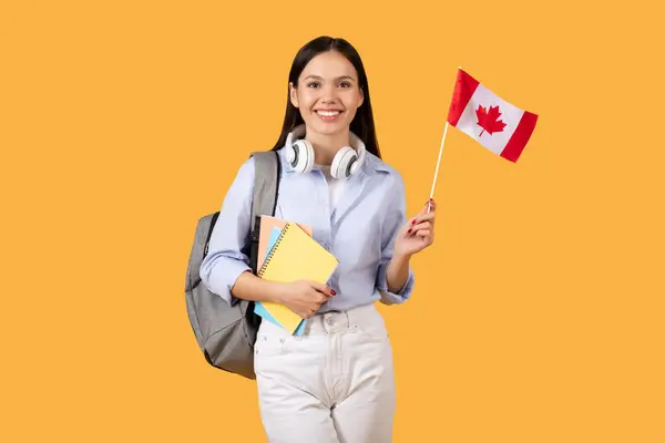 Χαρούμενη Φοιτήτρια Λαμπερό Χαμόγελο Κρατά Καναδική Σημαία Και Σημειωματάρια Ακουστικά — Φωτογραφία Αρχείου