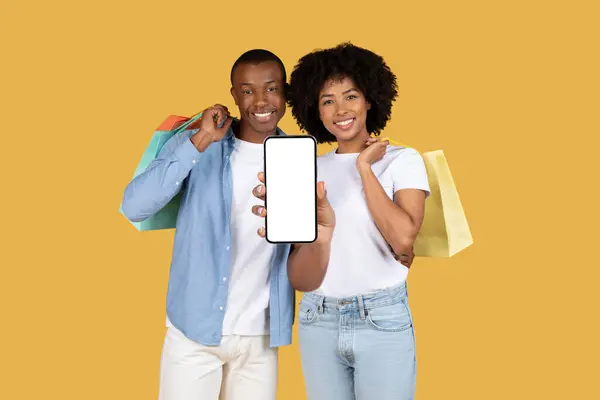 Smiling Millennial African American Couple Happily Displaying Smartphone Blank Screen — Stock Photo, Image