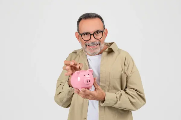 Smiling Senior Man Holding Inserting Coin Pink Piggy Bank Happy — Stock Photo, Image