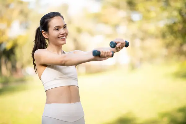 Radiant Glad Caucasian Young Woman Athlete Exercises Dumbbells Outdoors Her — Stock Photo, Image