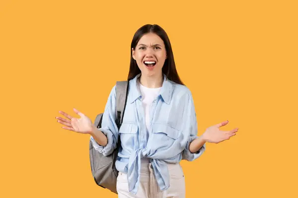 Young Woman Casual Attire Wearing Backpack Displays Animated Expression Annoyance — Stock Photo, Image