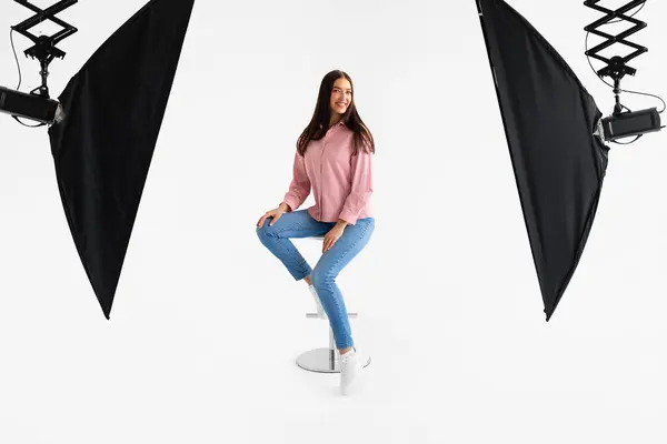 Young Woman Soft Pink Blouse Fitted Blue Jeans Strikes Relaxed — Stock Photo, Image