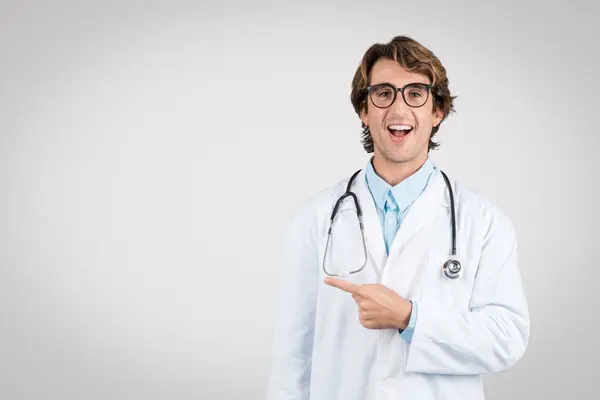 Exuberant Young Male Doctor Glasses Lab Coat Pointing Free Space — Stock Photo, Image